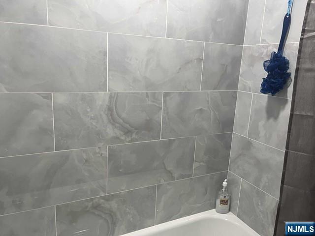 259 MacArthur Avenue, Unit 2 Garfield, NJ 07026 - Photo 9 of 12 a bathroom with a shower