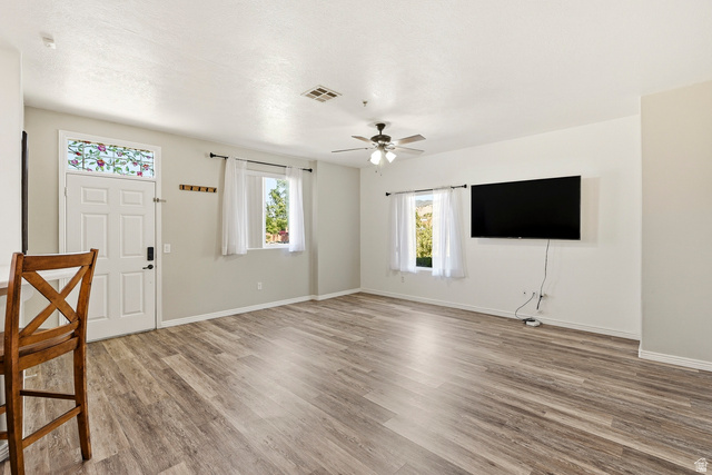 1177 Northfield Road, Unit 26 Cedar City, UT 84721 - Photo 6 of 45 Spacious living area featuring wood-finish flooring, light gray wall paint, and multiple windows