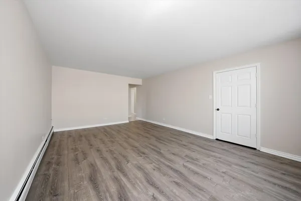 an empty room with wooden floor