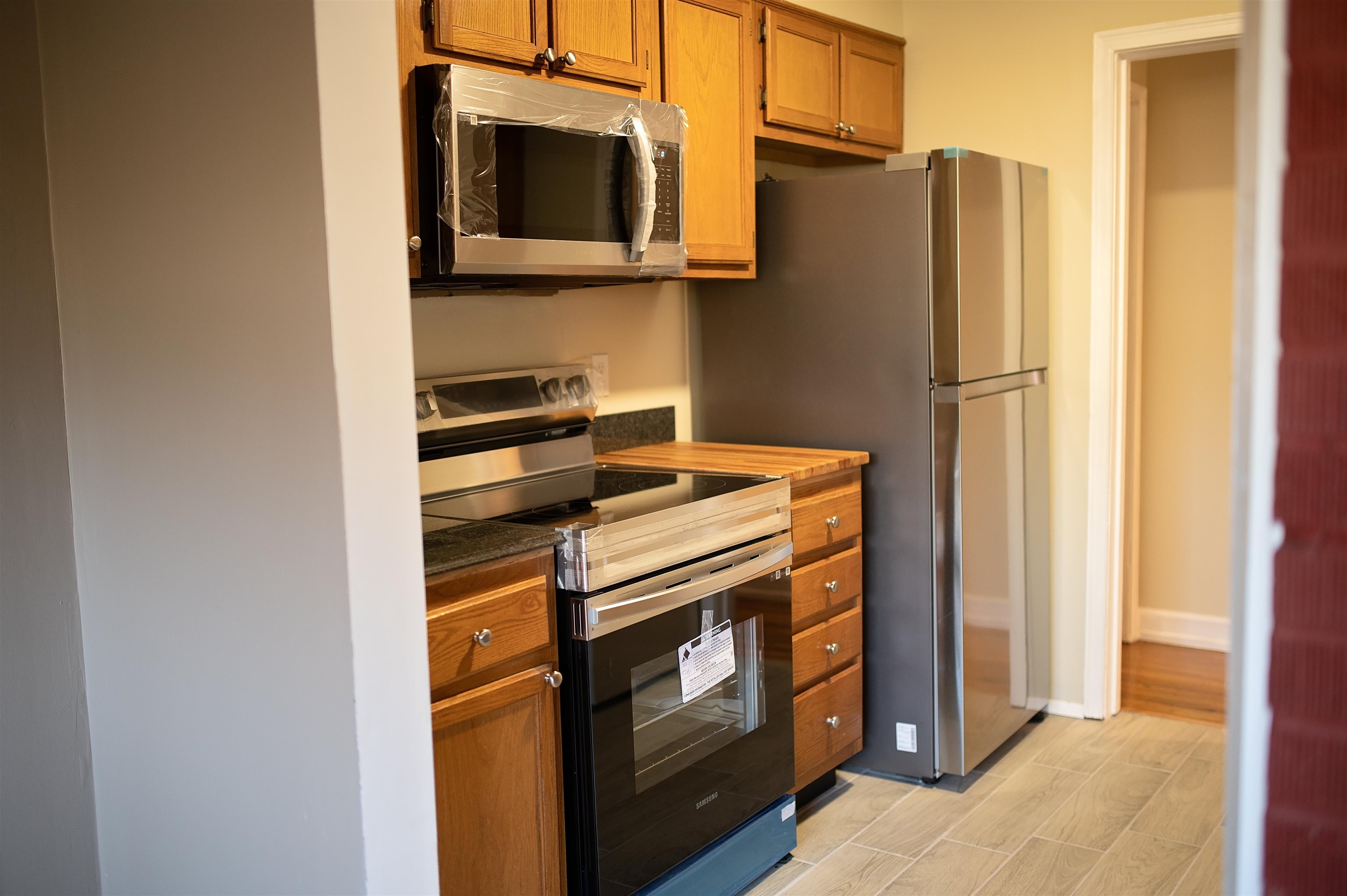 1351 Marcia Road Memphis, TN 38117 - Photo 4 of 10 a kitchen with a refrigerator stove and microwave