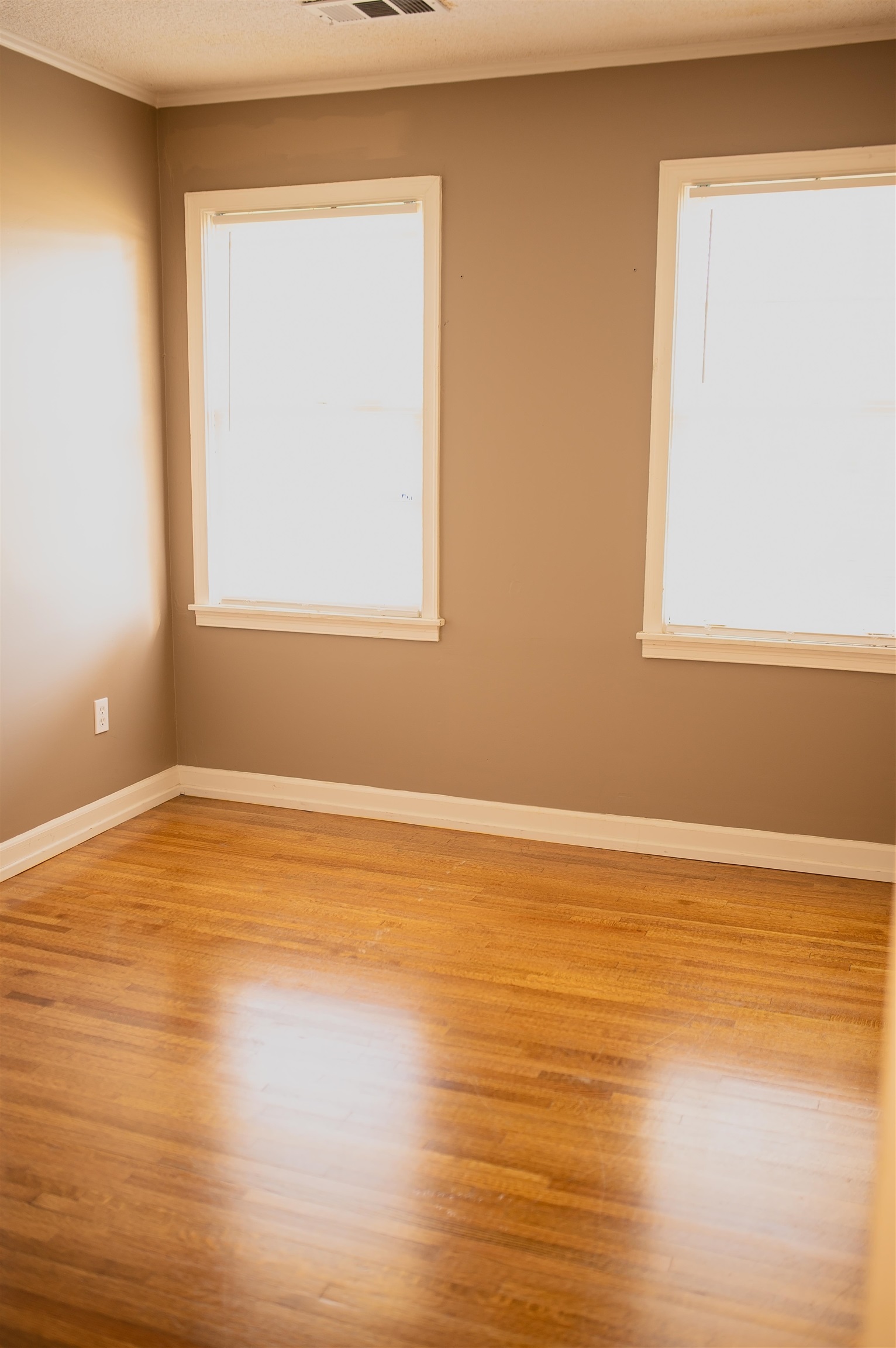 1351 Marcia Road Memphis, TN 38117 - Photo 7 of 10 a view of an empty room with wooden floor and a window
