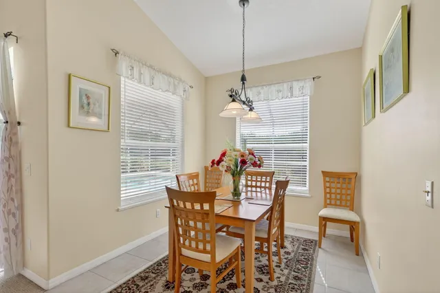 a dining room with furniture and window