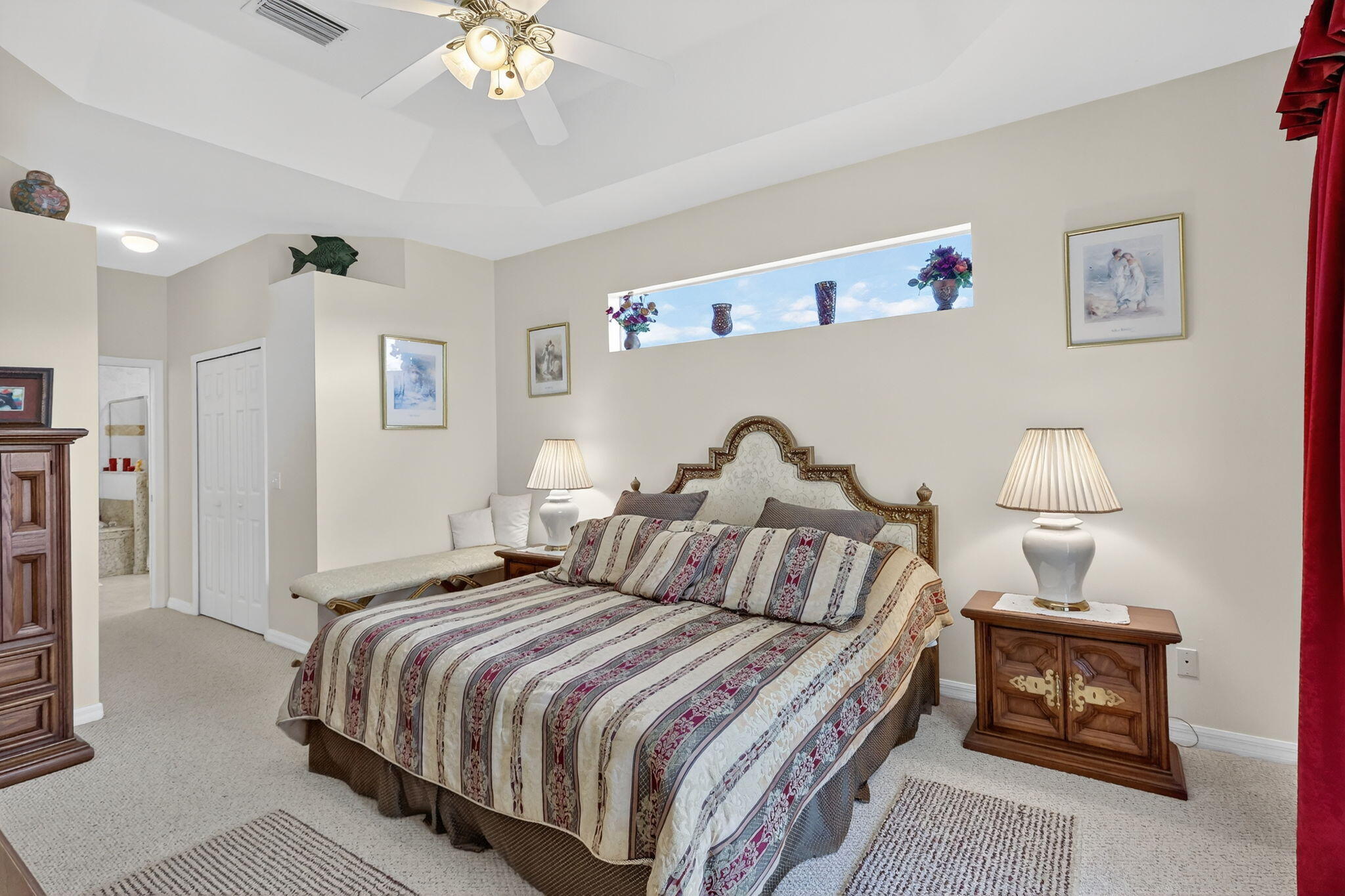 3075 73rd Place Vero Beach, FL 32967 - Photo 19 of 65 a bedroom with bed and a chandelier