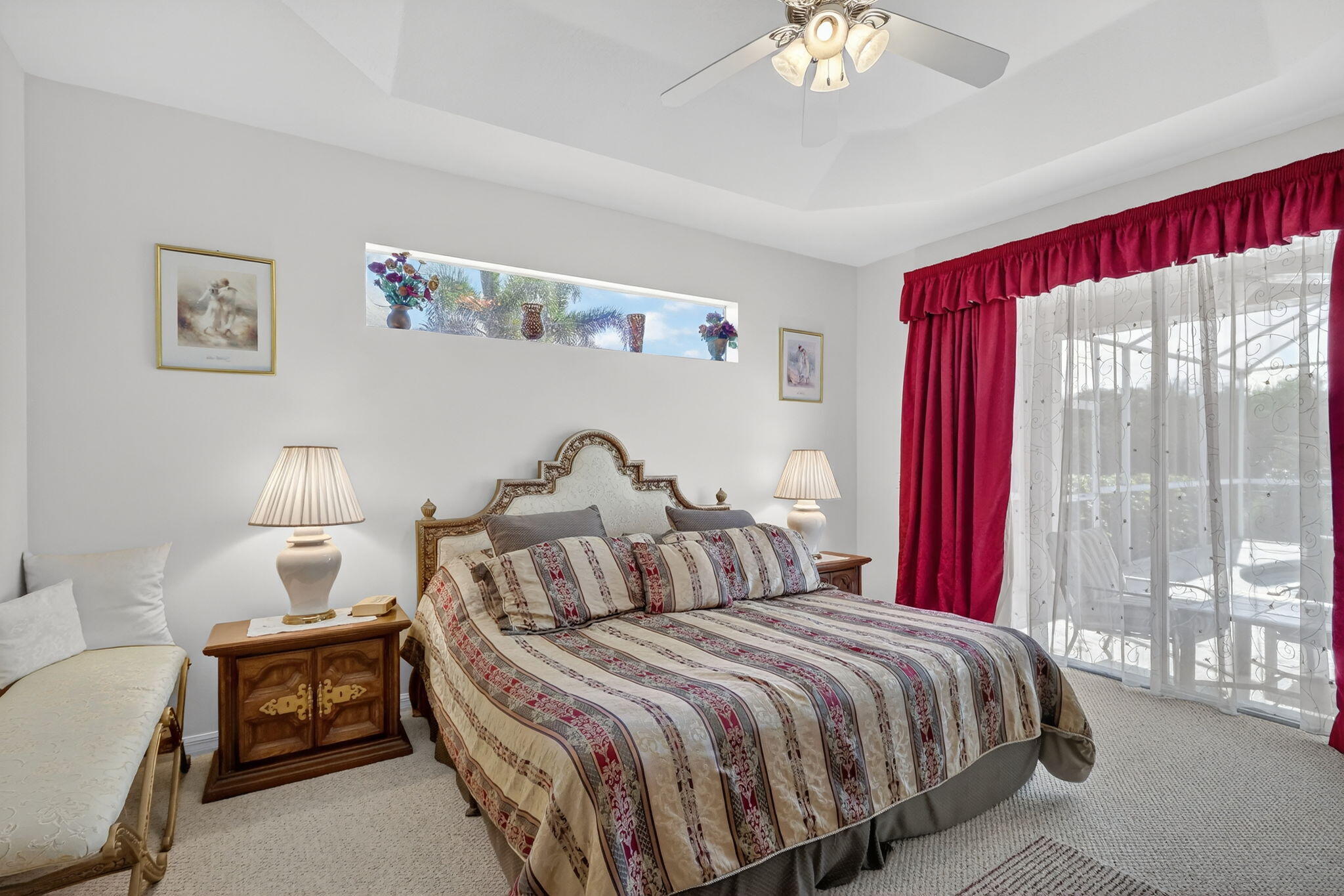 3075 73rd Place Vero Beach, FL 32967 - Photo 21 of 65 a bedroom with a bed and a chandelier