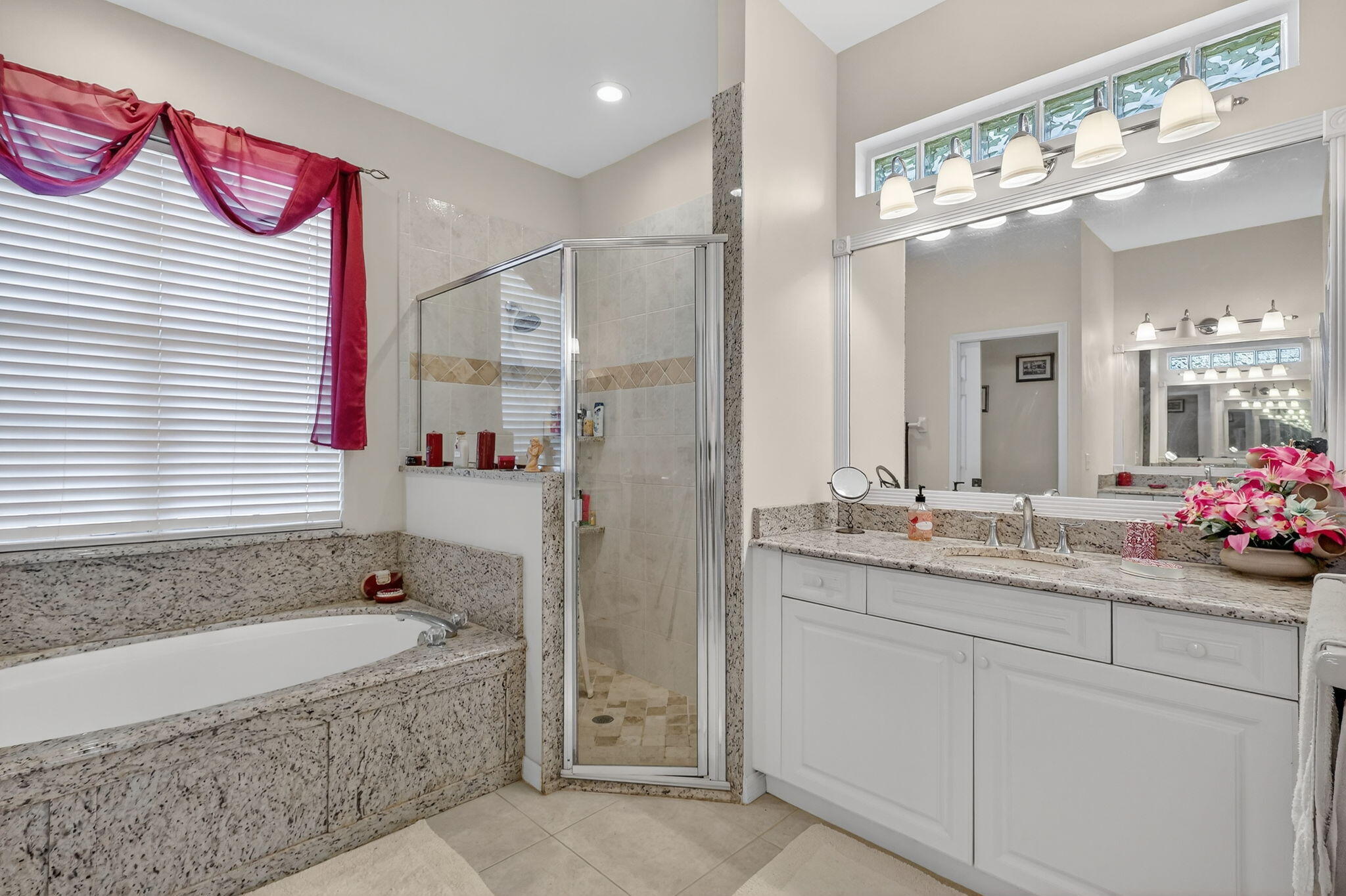 3075 73rd Place Vero Beach, FL 32967 - Photo 23 of 65 a bathroom with a granite countertop sink mirror and a bathtub