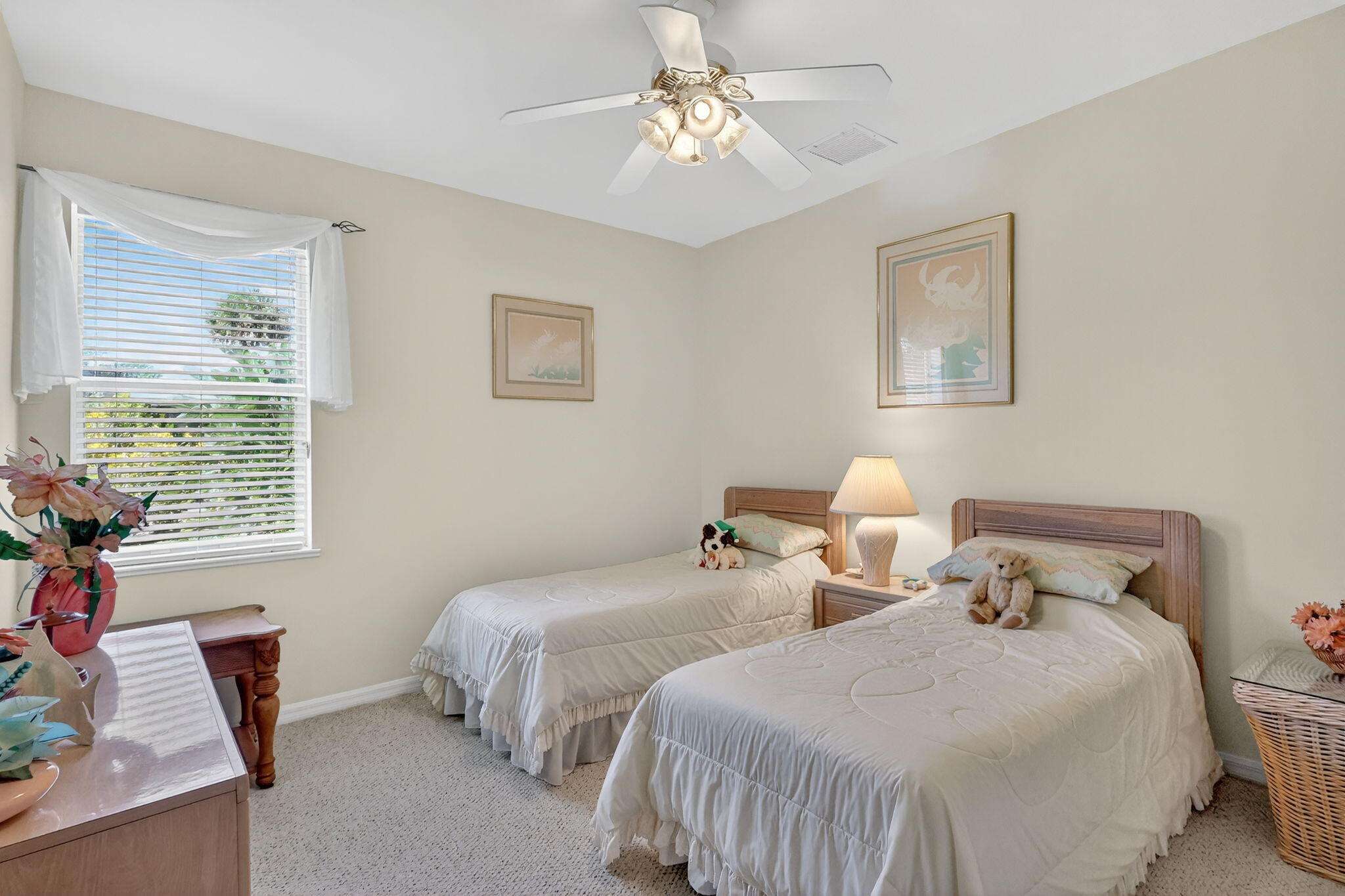 3075 73rd Place Vero Beach, FL 32967 - Photo 28 of 65 a bedroom with two beds and a chandelier