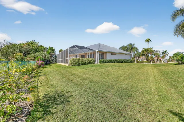 an aerial view of a house with yard swimming pool and outdoor seating