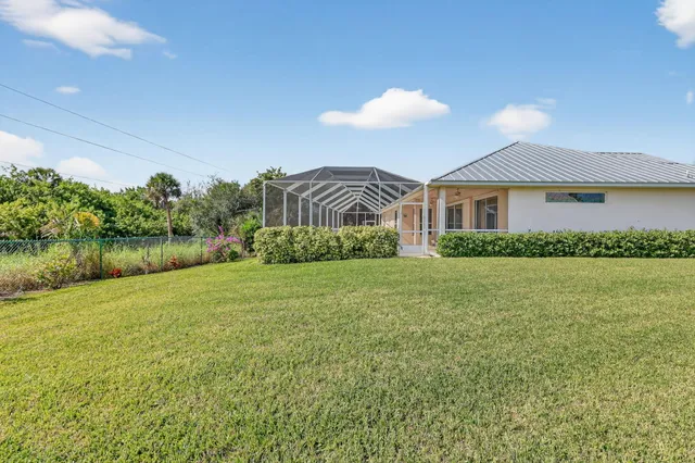 an aerial view of a house with yard swimming pool and outdoor seating