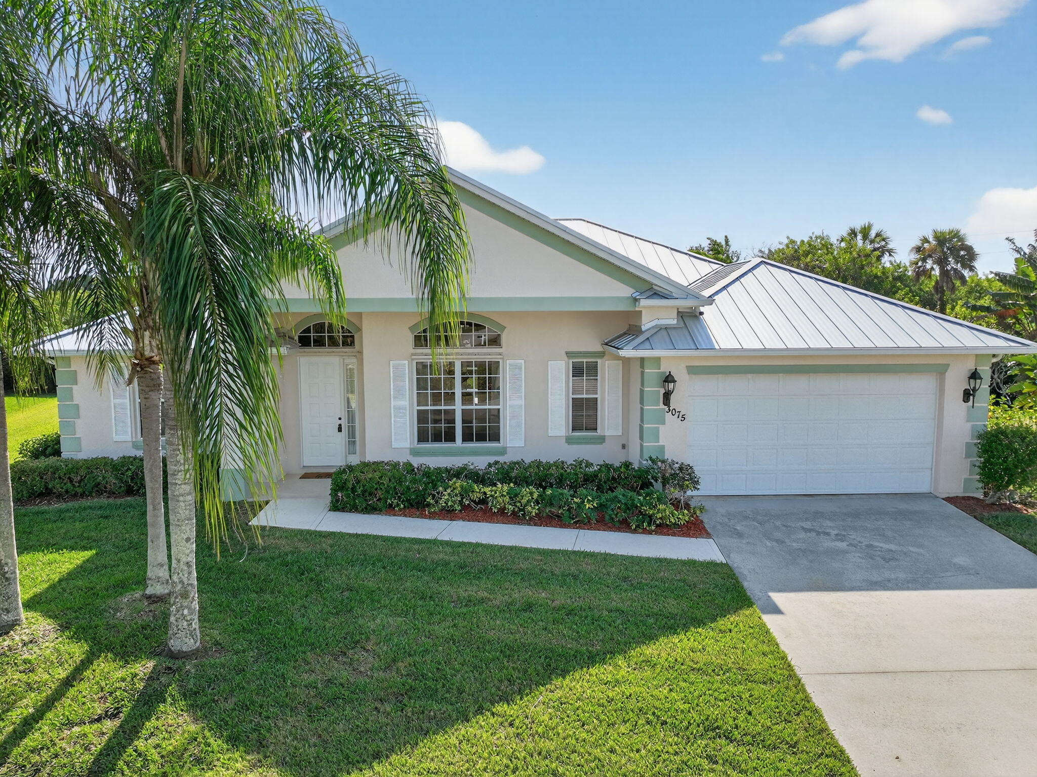 3075 73rd Place Vero Beach, FL 32967 - Photo 45 of 65 a front view of a house with a garden