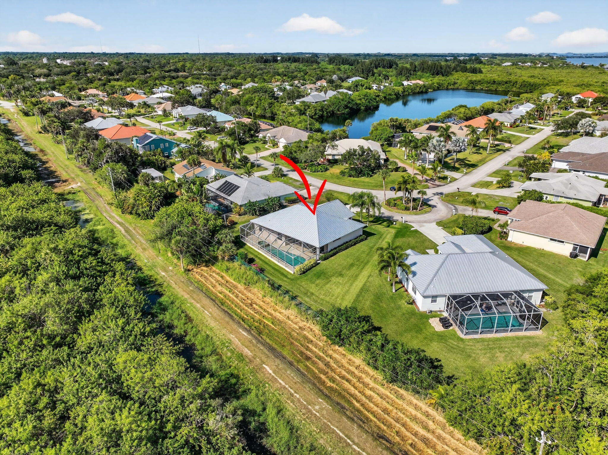 3075 73rd Place Vero Beach, FL 32967 - Photo 52 of 65 an aerial view of residential houses with outdoor space and street view