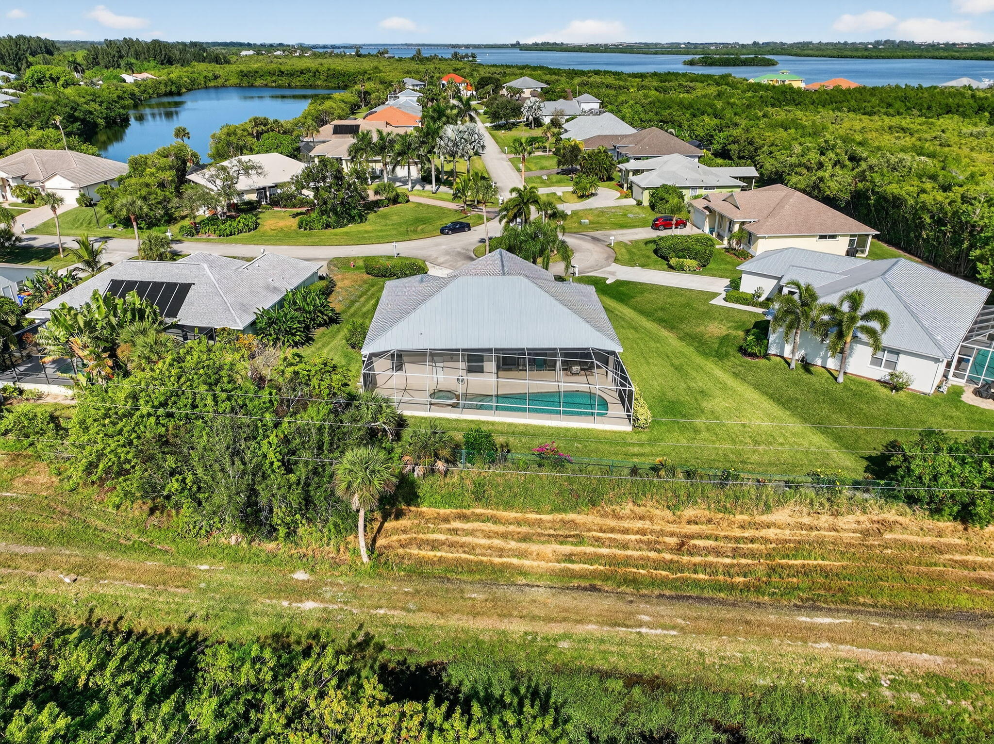 3075 73rd Place Vero Beach, FL 32967 - Photo 56 of 65 an aerial view of residential houses with outdoor space and swimming pool