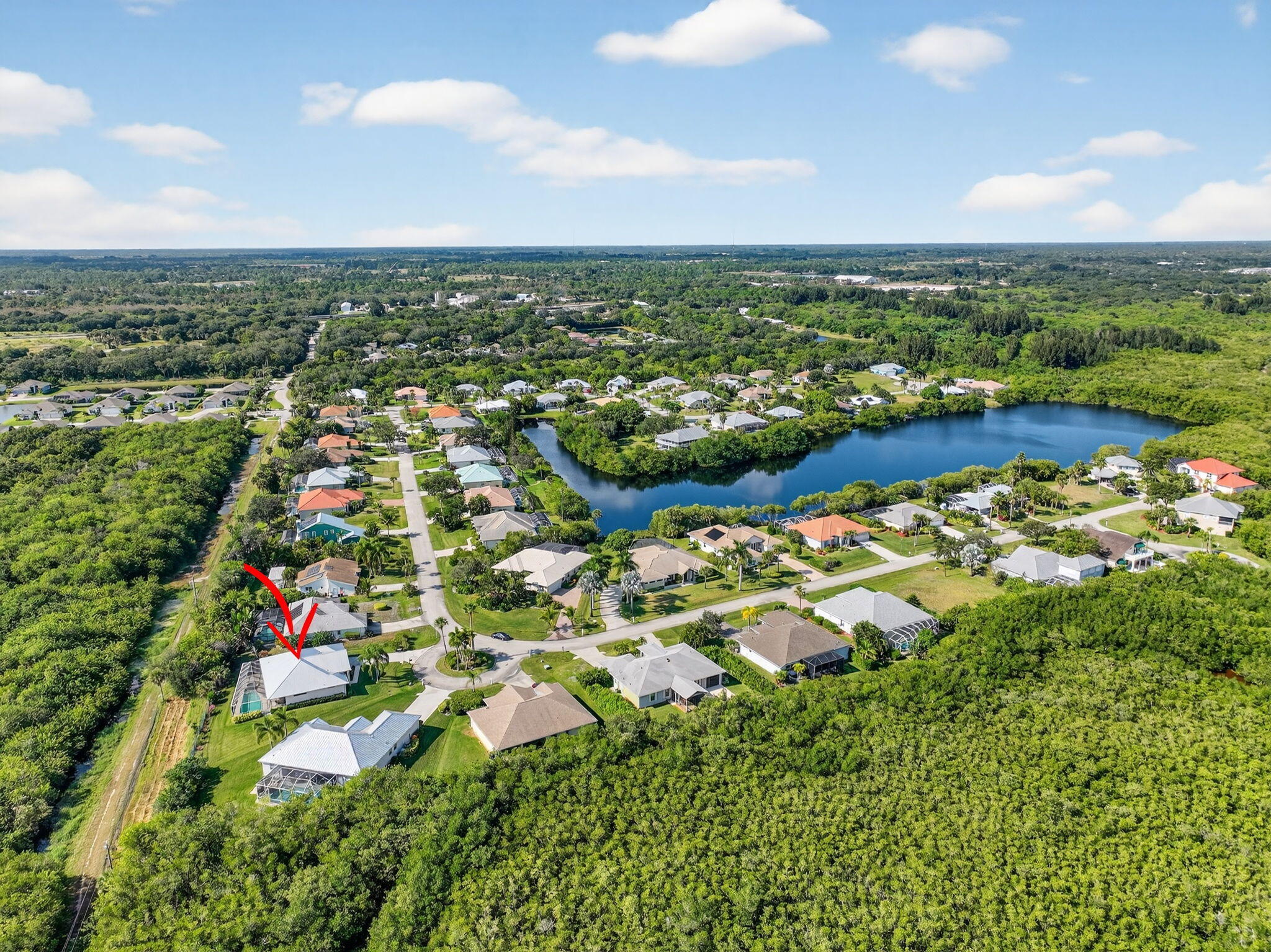 3075 73rd Place Vero Beach, FL 32967 - Photo 60 of 65 an aerial view of residential houses with outdoor space and trees