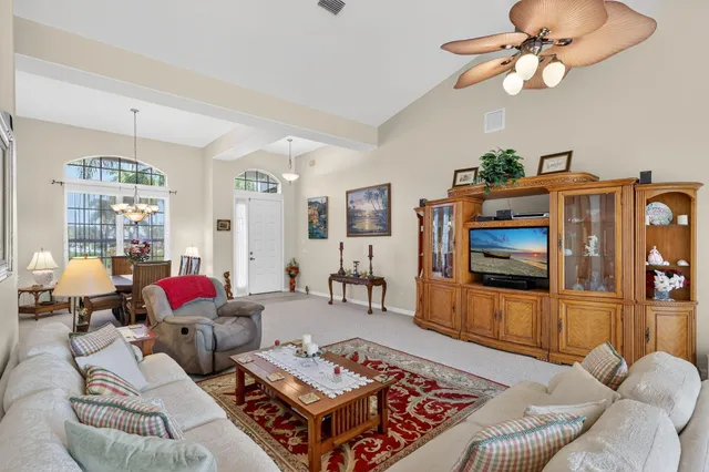 a living room with furniture fireplace and flat screen tv