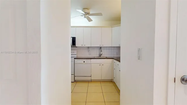 a kitchen with a sink cabinets and a window