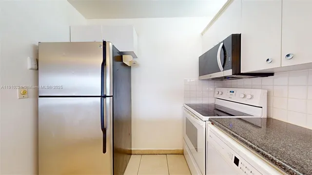a kitchen with a refrigerator sink and microwave
