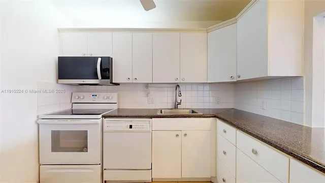 a kitchen with cabinets stainless steel appliances and a sink