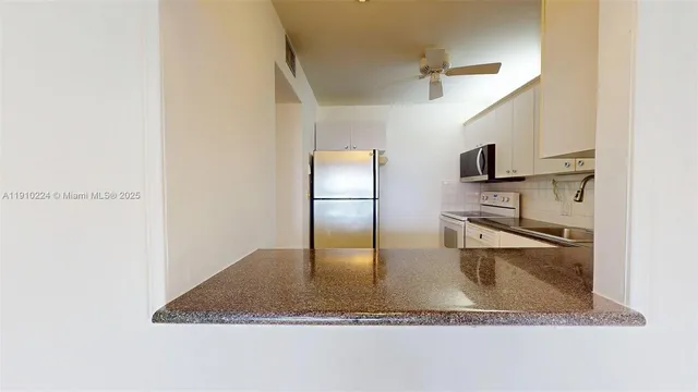 a bathroom with a granite countertop sink a mirror and window
