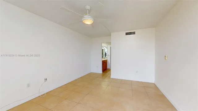 a view of a livingroom with a ceiling fan and window
