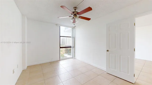 a view of a livingroom with a ceiling fan & a ceiling fan