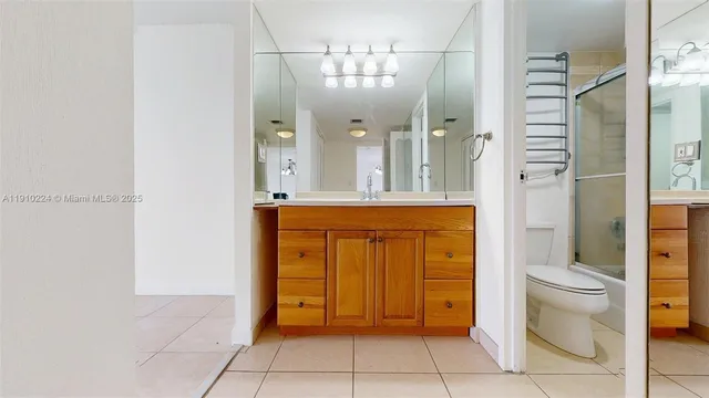 a bathroom with a double vanity sink mirror and shower