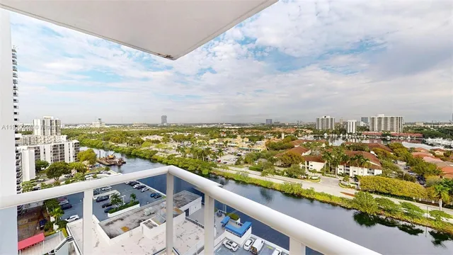 a view of roof deck with table and chairs potted plants with wooden floor
