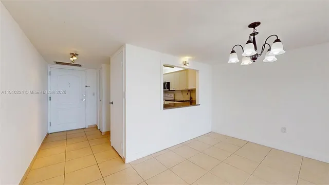 a view of a livingroom with wooden floor and chandelier