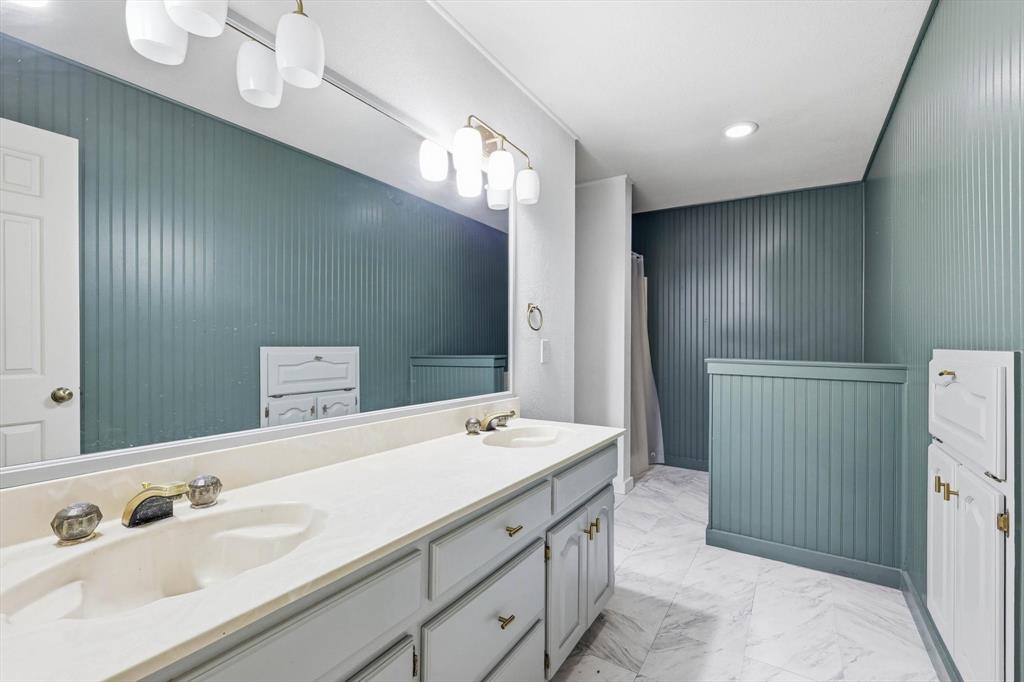 211 Bayne Road Haslet, TX 76052 - Photo 19 of 29 a spacious bathroom with a double vanity sink and a mirror