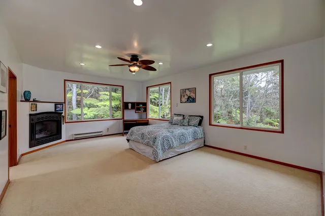 a spacious bedroom with a large bed and a large window