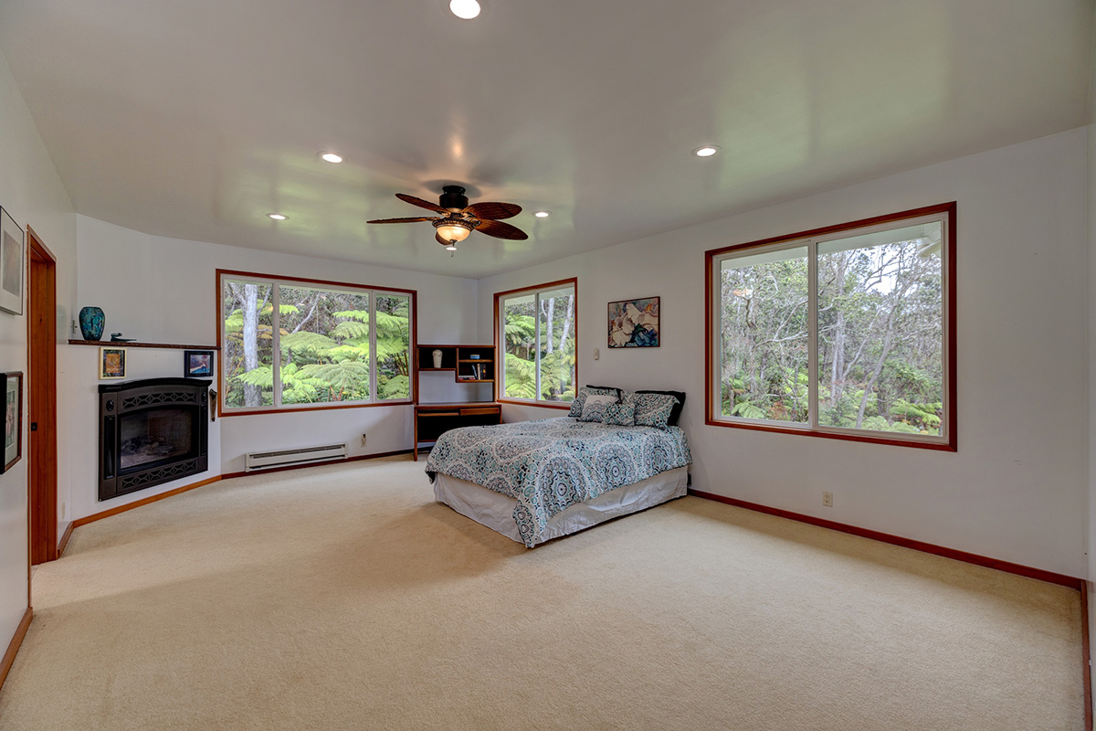 19-4221 Haunani Road Volcano, HI 96785 - Photo 11 of 30 a spacious bedroom with a large bed and a large window