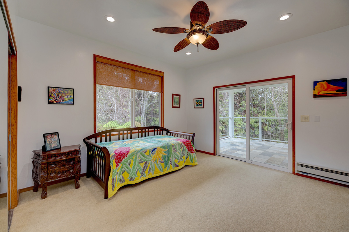 19-4221 Haunani Road Volcano, HI 96785 - Photo 15 of 30 a bedroom with a bed and a large window