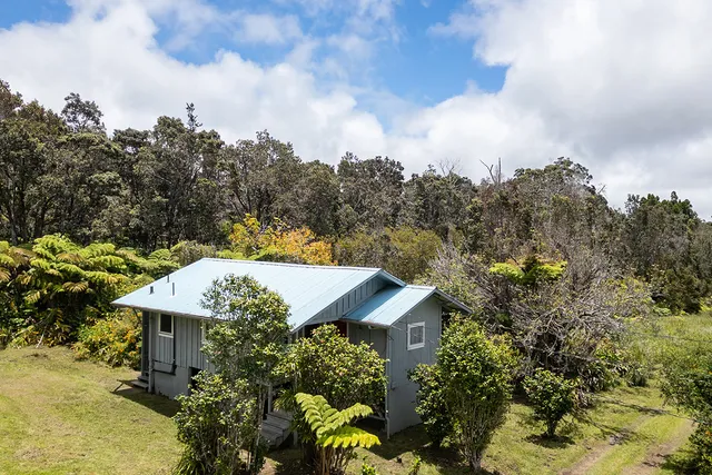 an aerial view of a house with a yard basket ball court and outdoor seating