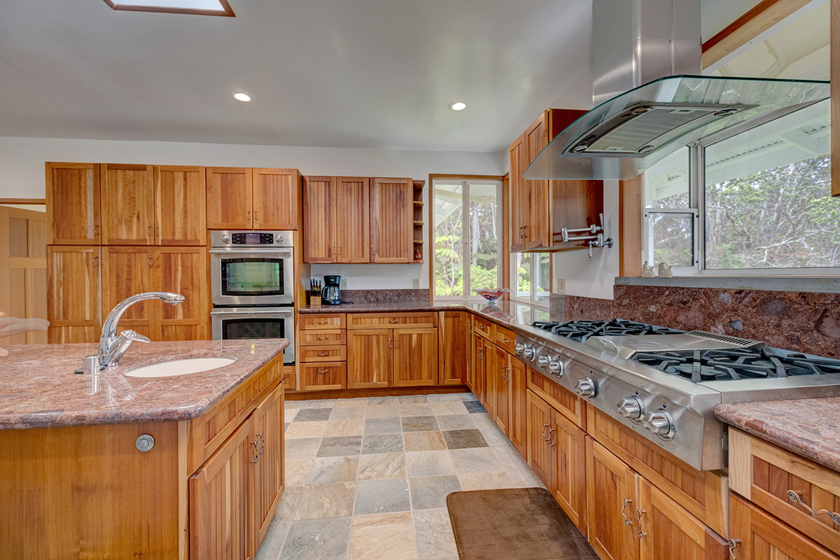 19-4221 Haunani Road Volcano, HI 96785 - Photo 9 of 30 a kitchen with a stove a sink and a microwave