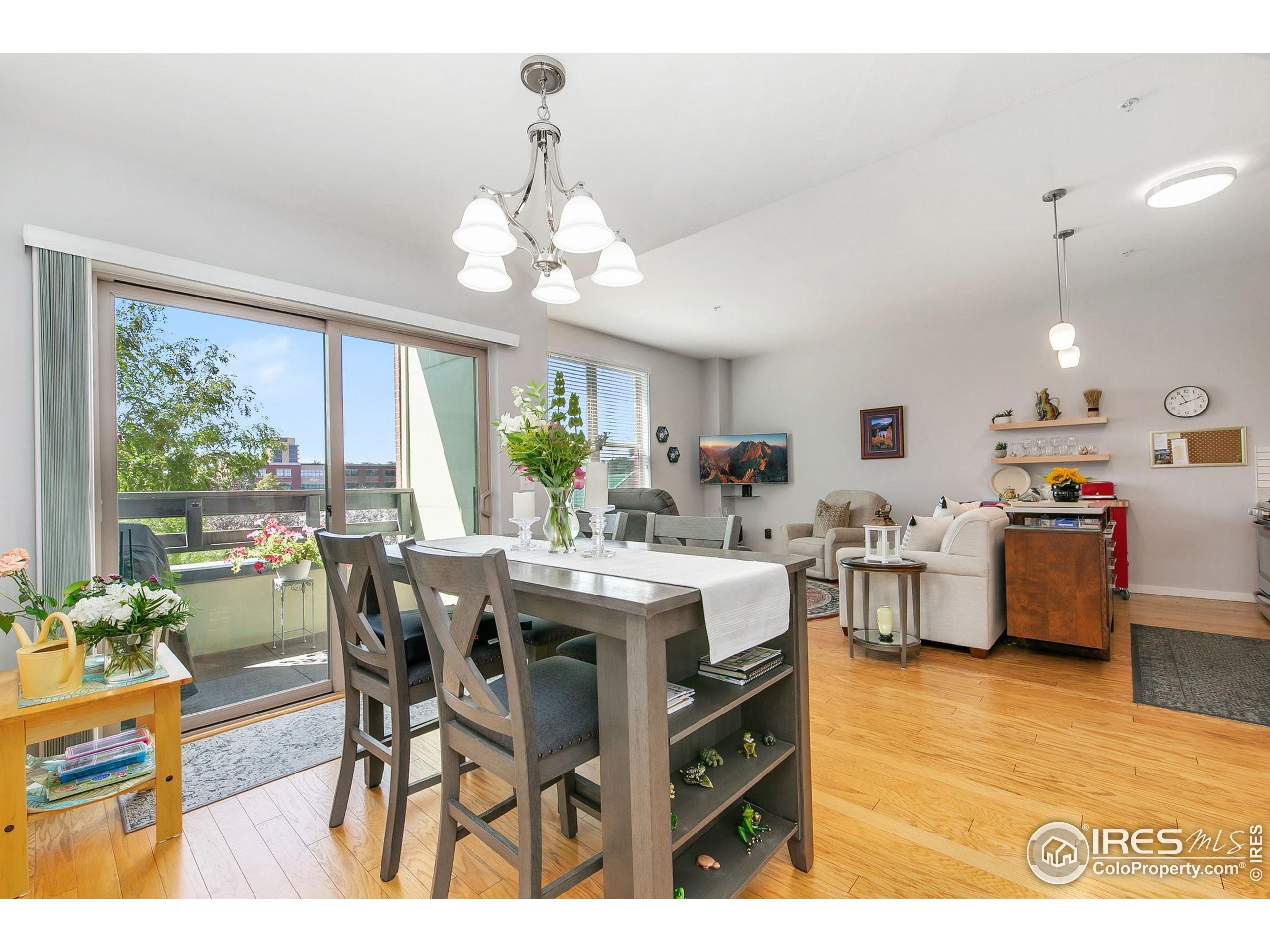 204 Maple Street, Unit 207 Fort Collins, CO 80521 - Photo 15 of 21 a view of a dining room with furniture and a chandelier