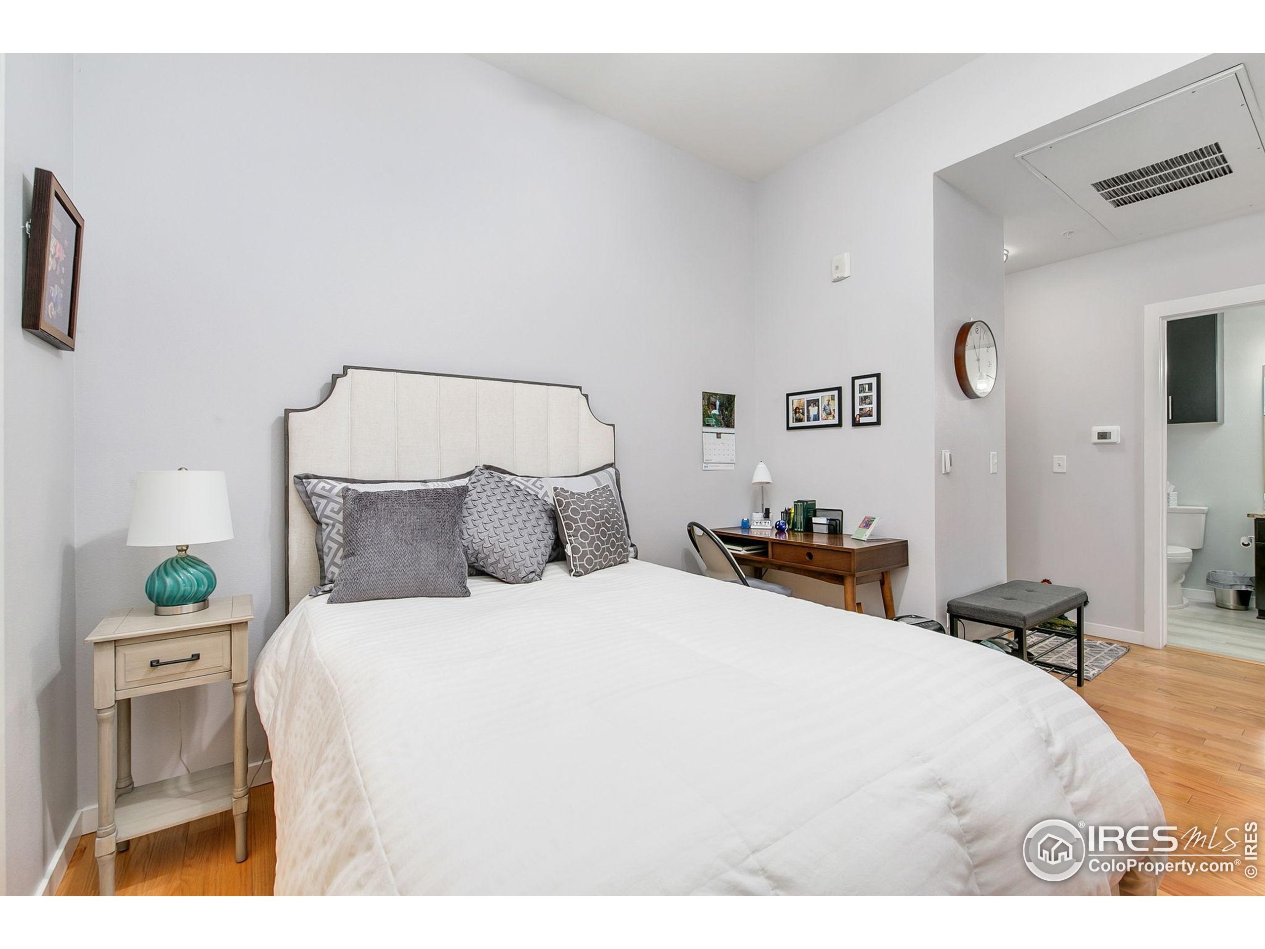 204 Maple Street, Unit 207 Fort Collins, CO 80521 - Photo 7 of 21 a bedroom with a bed and a couch
