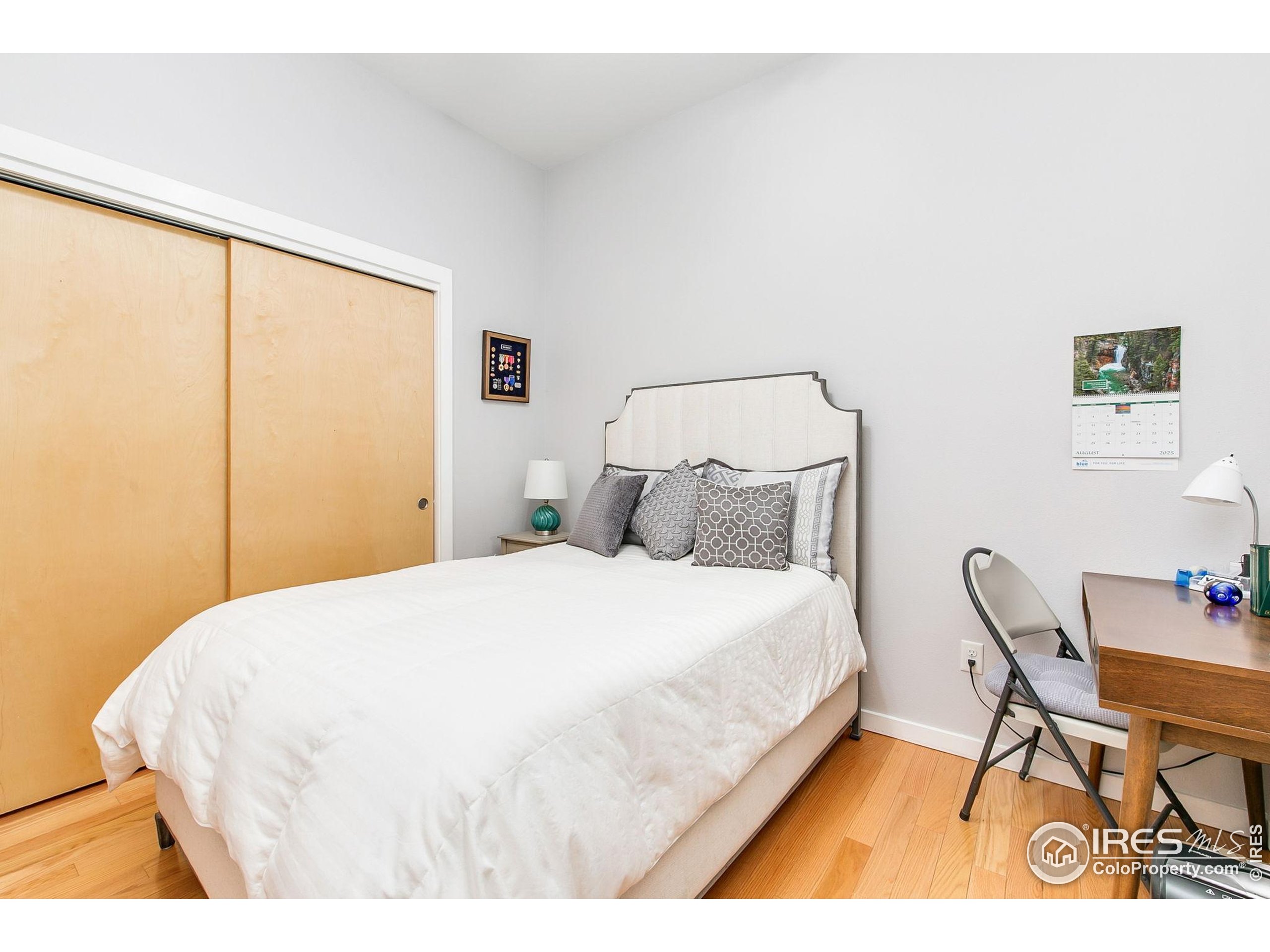 204 Maple Street, Unit 207 Fort Collins, CO 80521 - Photo 8 of 21 a large bed sitting in a bedroom next to a window