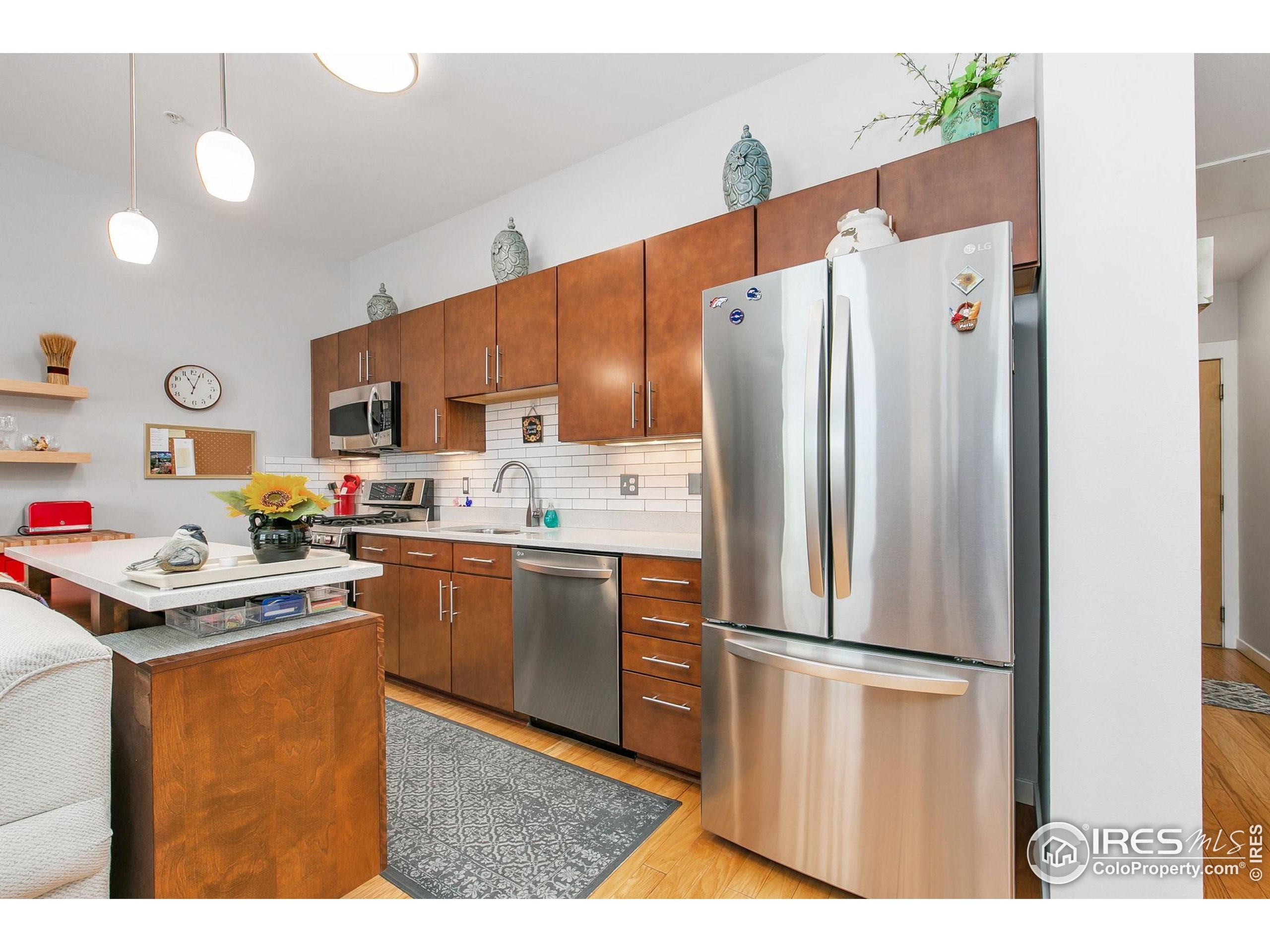 204 Maple Street, Unit 207 Fort Collins, CO 80521 - Photo 10 of 21 a kitchen with stainless steel appliances a refrigerator sink and microwave