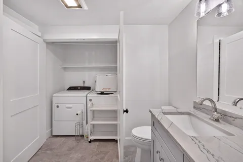 a bathroom with a sink toilet vanity and tub