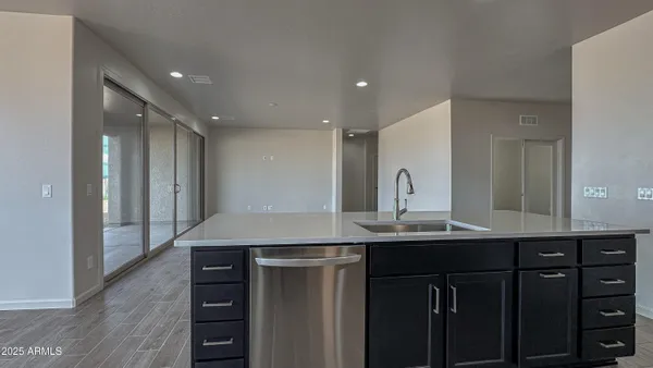 a kitchen with kitchen island a sink appliances and cabinets