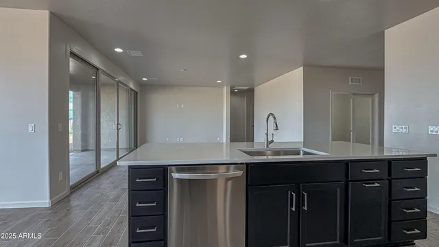 a kitchen with kitchen island a sink appliances and cabinets