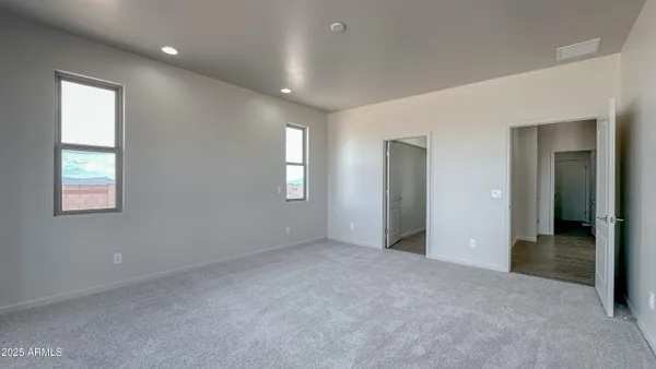 an empty room with windows and closet