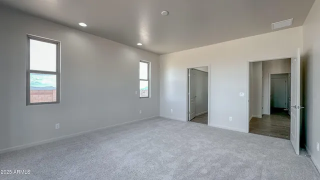an empty room with windows and closet