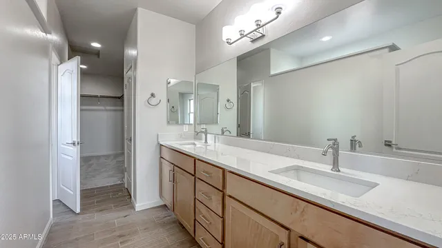 a bathroom with a sink double vanity and a mirror
