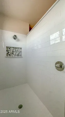 a bathroom with a shower and a sink