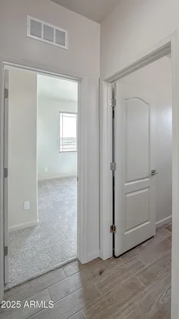 a view of a room with wooden floor