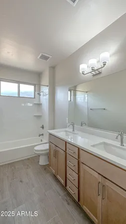 a bathroom with a tub sink and mirror