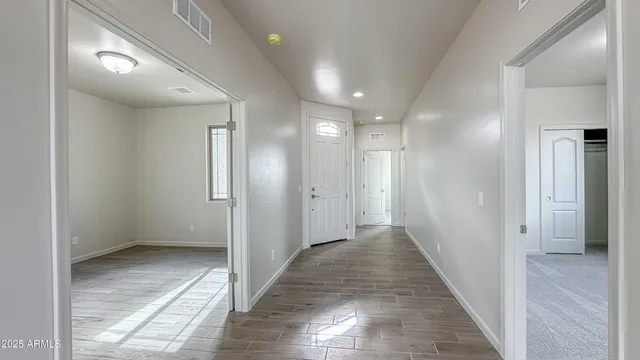 a view of hallway with wooden floor