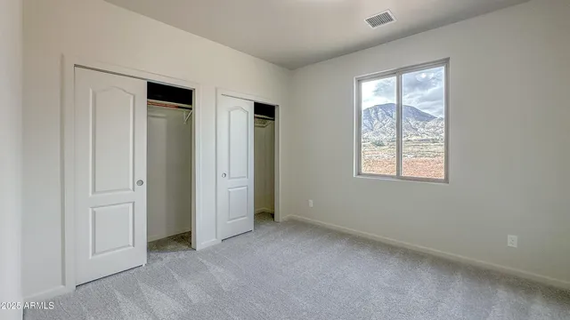 an empty room with windows and closet