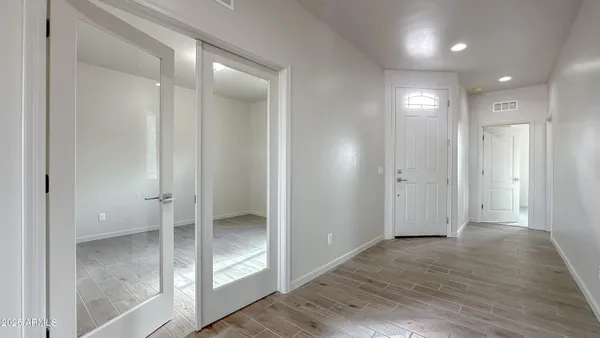 a view of a room with wooden floor