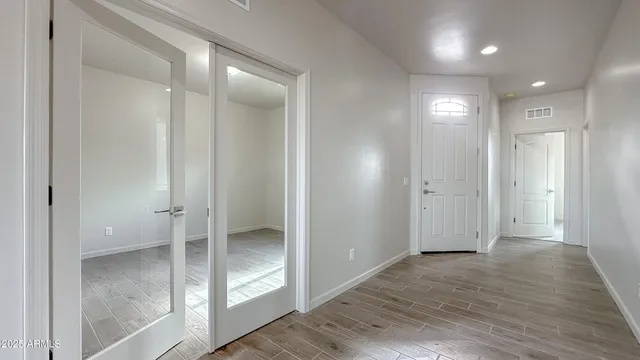 a view of a room with wooden floor