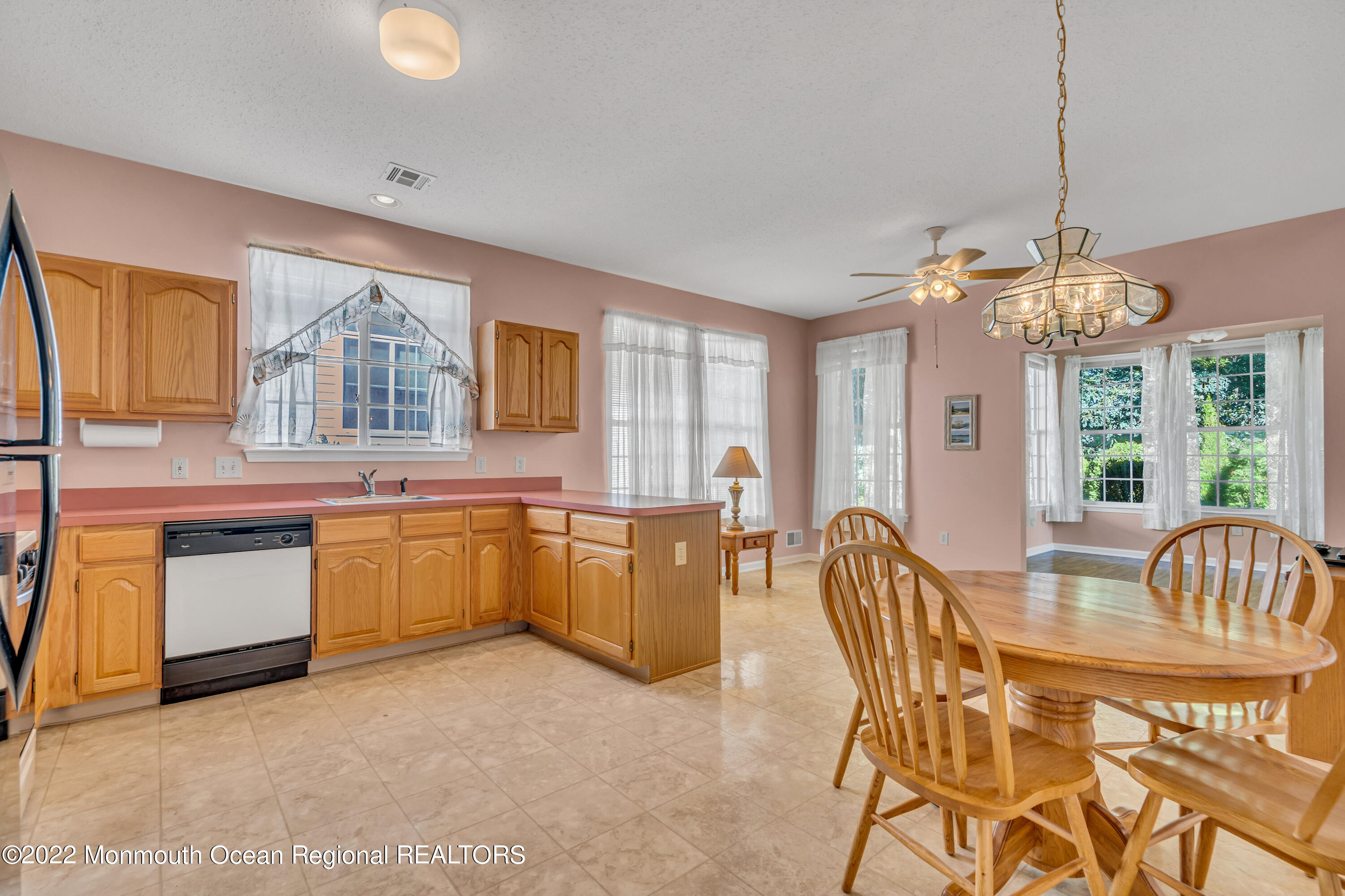 59 Quail Road Barnegat, NJ 08005 - Photo 11 of 30 a kitchen with granite countertop a stove a sink a dining table and chairs with wooden floor